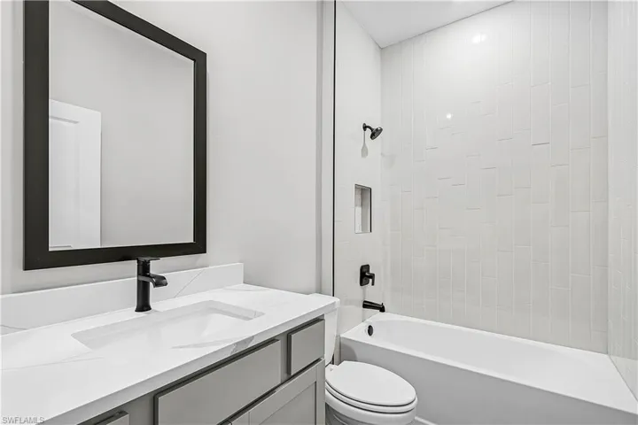 Full bath featuring  shower combination and vanity