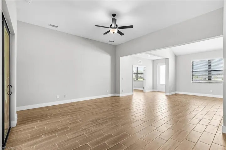 Spare room featuring wood finish floors and ceiling fan