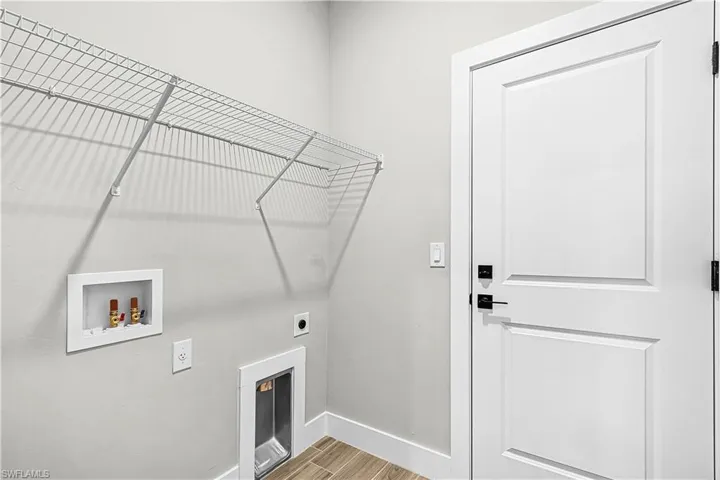 Washroom featuring light wood finished floors, washer hookup, and electric dryer hookup