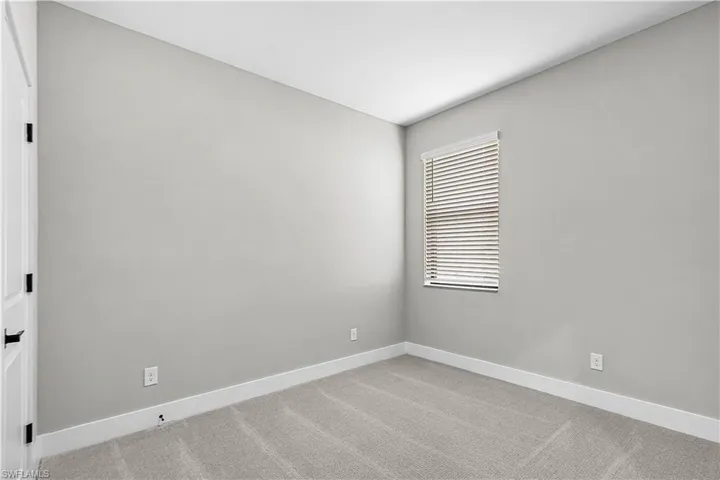 Carpeted spare room with baseboards