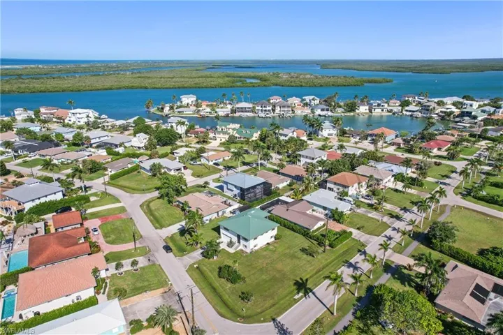 View of property location featuring a nearby body of water and nearby suburban area
