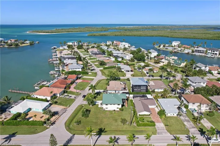 Aerial view of property and surrounding area with nearby suburban area and a nearby body of water