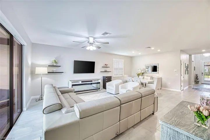 Living area featuring ceiling fan and recessed lighting