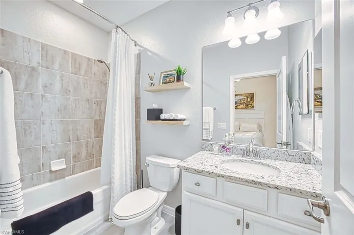 Bathroom ensuite featuring vanity, and shower / bath combo