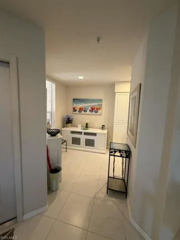 Corridor with baseboards and recessed lighting