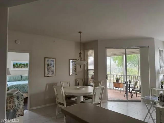 Dining room with baseboards and light tile patterned flooring
