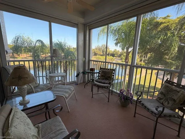 Sunroom featuring a ceiling fan, a balcony, and healthy amount of natural light