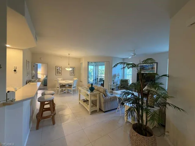 Living room featuring a ceiling fan and light tile patterned floors