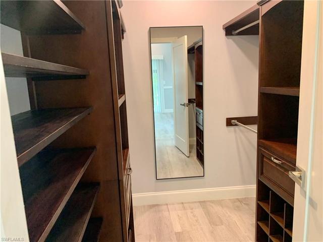 Walk-in closet with built-in drawers and plenty of shelving.
