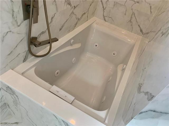 Jetted tub in master bath located toward back of shower with separate fill and spray system.