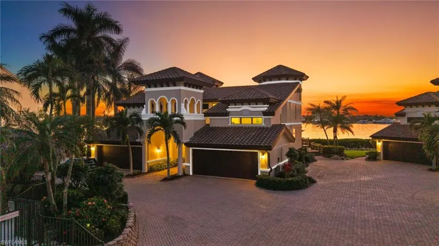 Mediterranean / spanish house with a garage and a water view