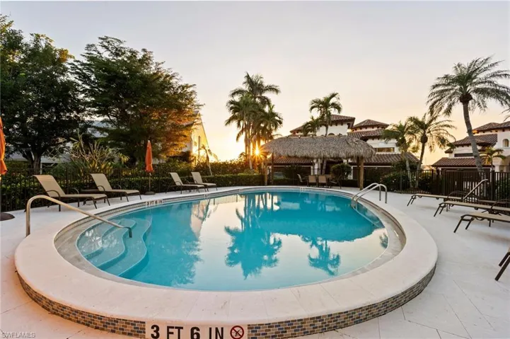 Pool at dusk with a gazebo and a patio