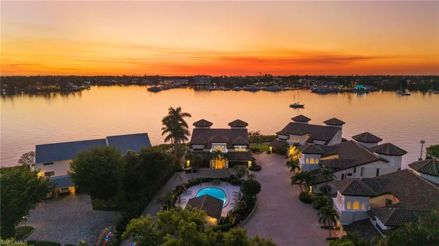 Aerial view at dusk featuring a water view