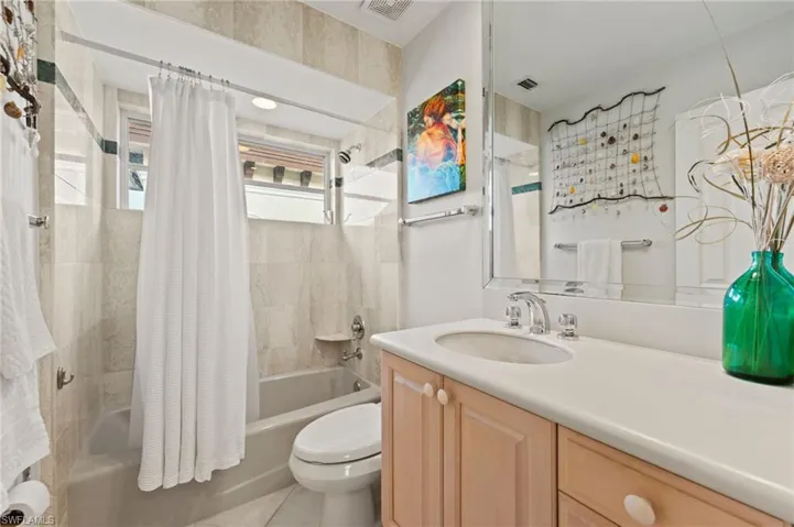 Full bathroom featuring tile patterned flooring, shower / bath combo, vanity, and toilet