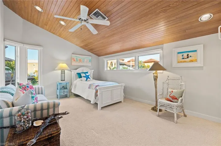 Carpeted bedroom featuring wooden ceiling, ceiling fan, and lofted ceiling
