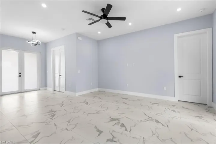 Unfurnished room featuring french doors, light marble finish floors, recessed lighting, and ceiling fan