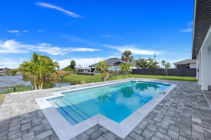 View of pool featuring a water view, a yard, and a patio area