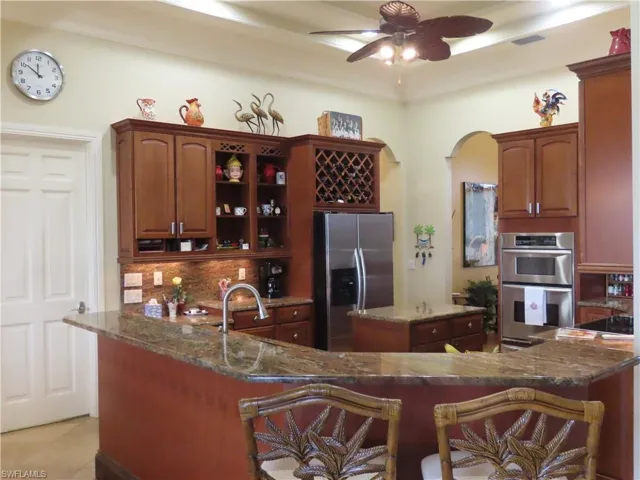 Kitchen with Granite Countertops, 48" Wood Cabinets, Island, Stainless Appl and under Cab lighting and tray ceiling with Crown Molding.