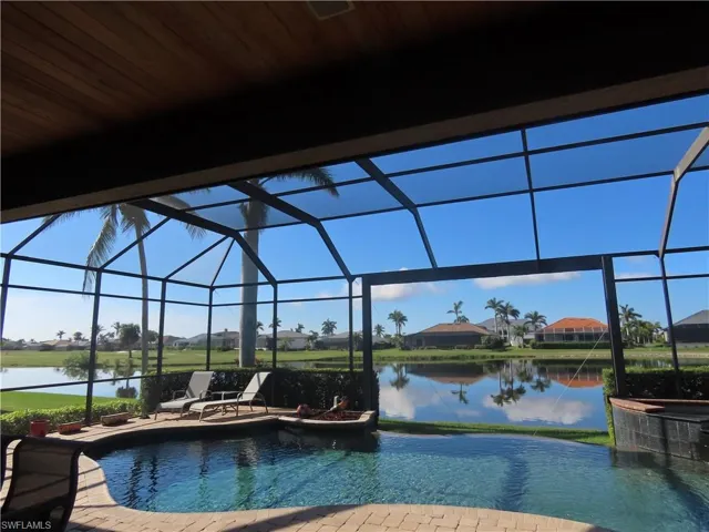 Pool with View thru Pool Cage Picture Window and Infinity edge from Lanai.