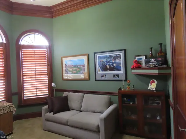 Office with Beautiful wood doors, wood plantation shutters, wood crown molding, closet, wood baseboard and wood chair rail.