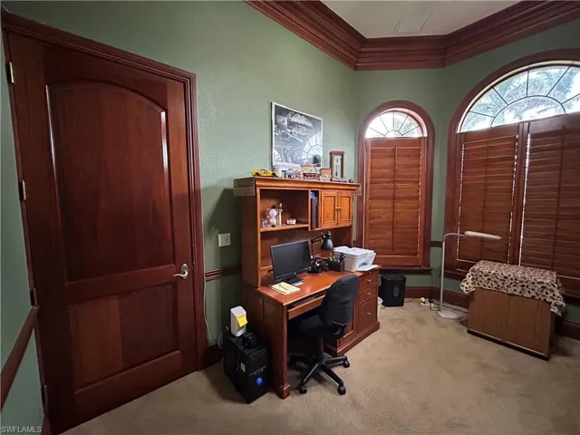 Office with Beautiful wood doors, wood plantation shutters, wood crown molding, closet, wood baseboard and wood chair rail.
