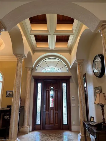 Entrance foyer with Wooden Door, with entrance pillars and coffered ceiling