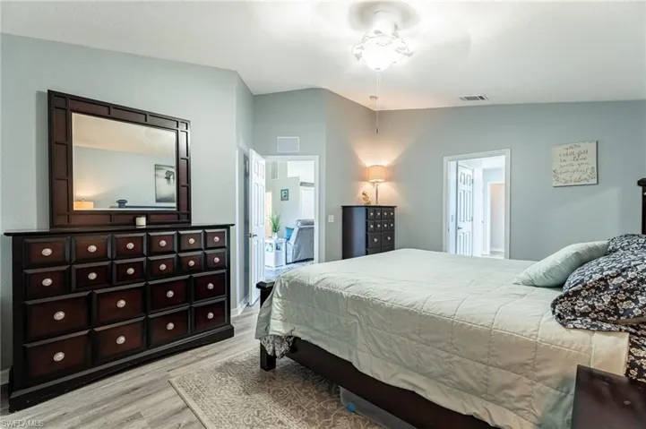 Bedroom with vaulted ceiling and light hardwood / wood-style flooring