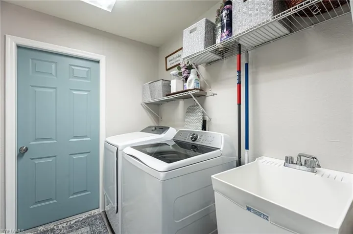Washroom with sink and independent washer and dryer