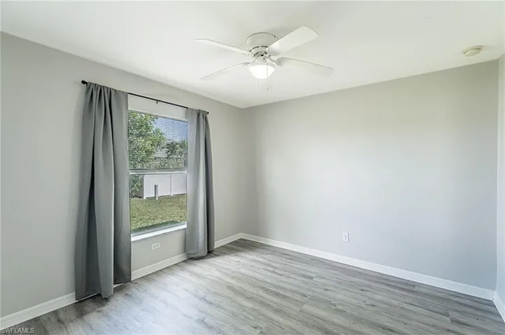 Empty room featuring ceiling fan and light hardwood / wood-style flooring