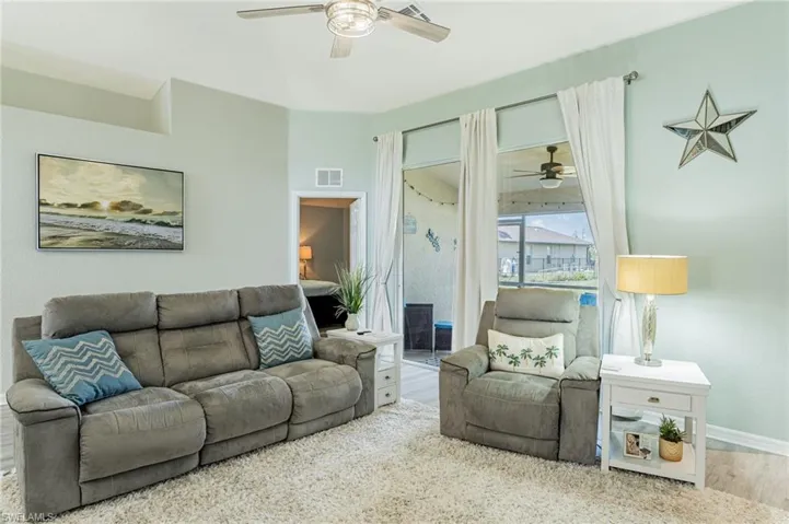 Living room with hardwood / wood-style flooring and ceiling fan