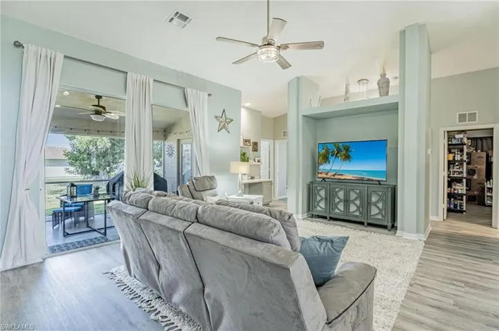 Living room featuring ceiling fan and hardwood / wood-style floors