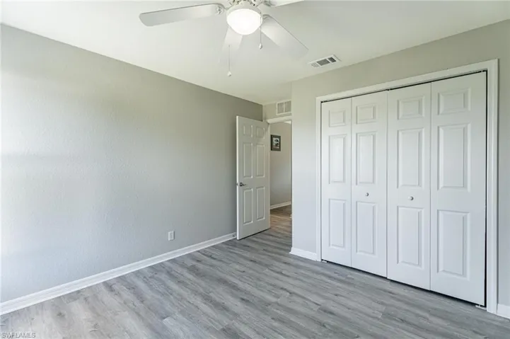 Unfurnished bedroom featuring a closet, ceiling fan, and hardwood / wood-style floors