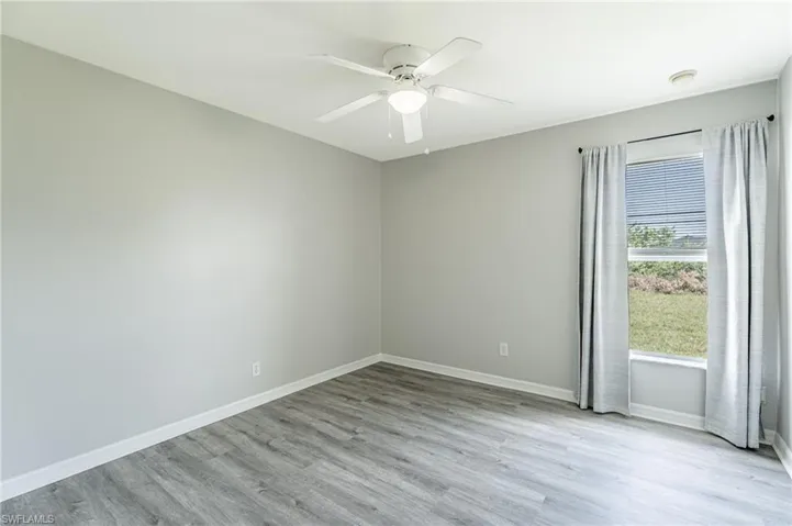 Spare room with ceiling fan and light hardwood / wood-style floors