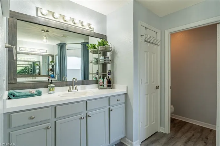 Bathroom featuring oversized vanity, hardwood / wood-style flooring, and toilet