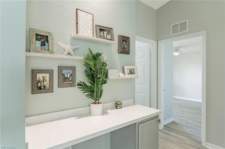 Bathroom featuring vanity, hardwood / wood-style flooring, and ceiling fan