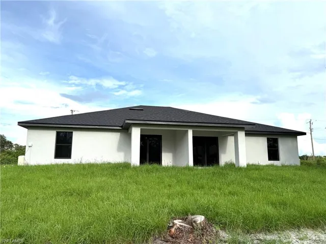 Rear view of property featuring stucco siding