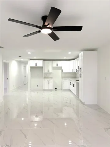 Unfurnished room with light marble finish flooring, recessed lighting, and a ceiling fan