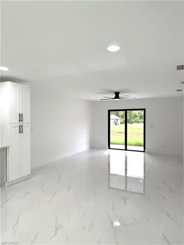 Empty room featuring light marble finish flooring, recessed lighting, and ceiling fan