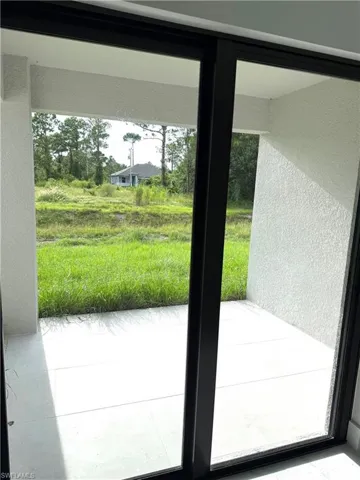Doorway to outside with a textured wall