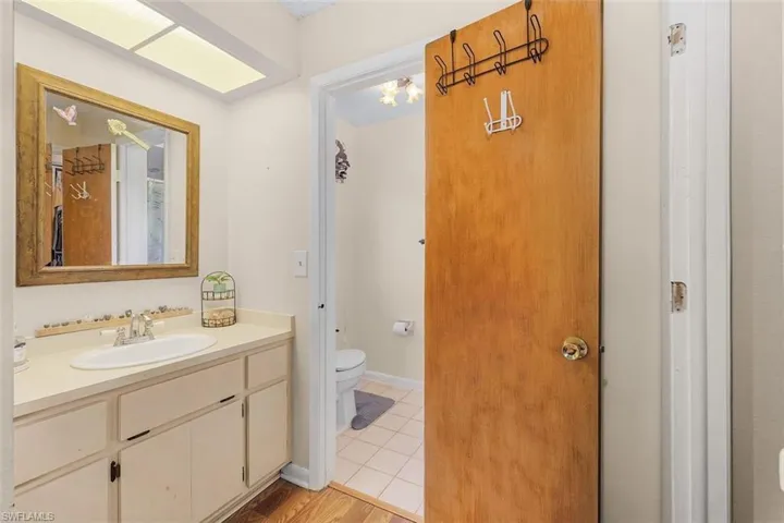 Bathroom with vanity, tile patterned floors, and toilet