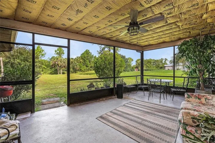 Sunroom / solarium featuring ceiling fan