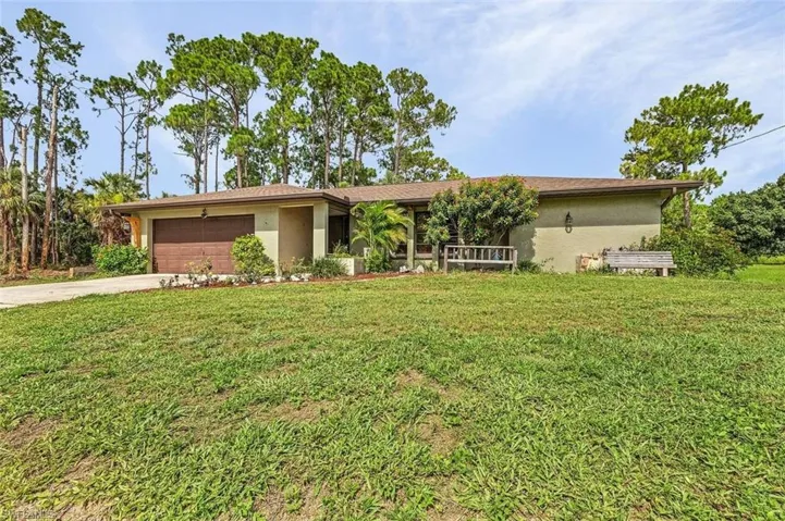 Ranch-style home with a garage and a front yard
