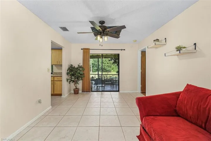 Sitting room featuring tile patterned floors and ceiling fan