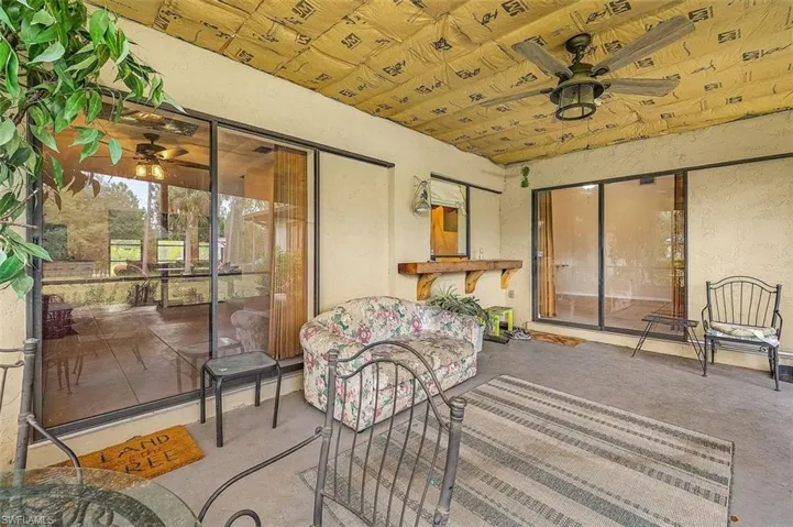 Sunroom / solarium with wood ceiling and ceiling fan