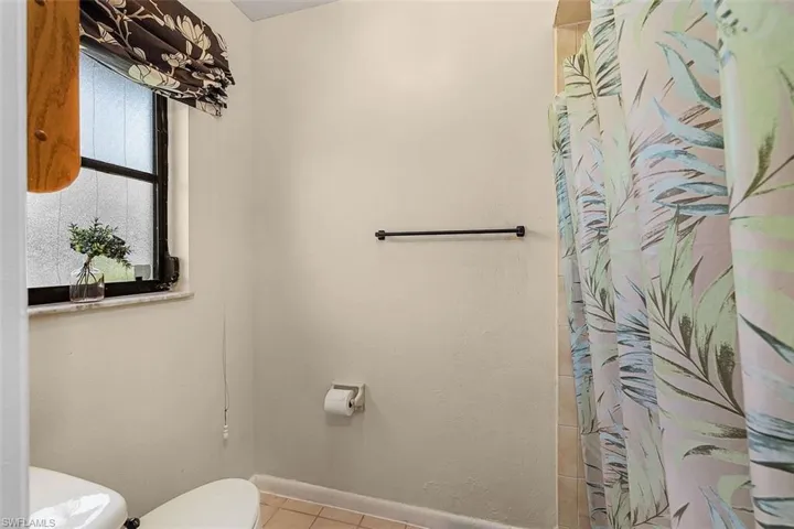 Bathroom with tile patterned floors and toilet