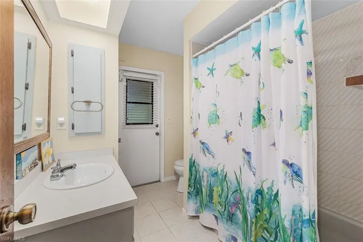 Bathroom with tile patterned flooring, toilet, and vanity