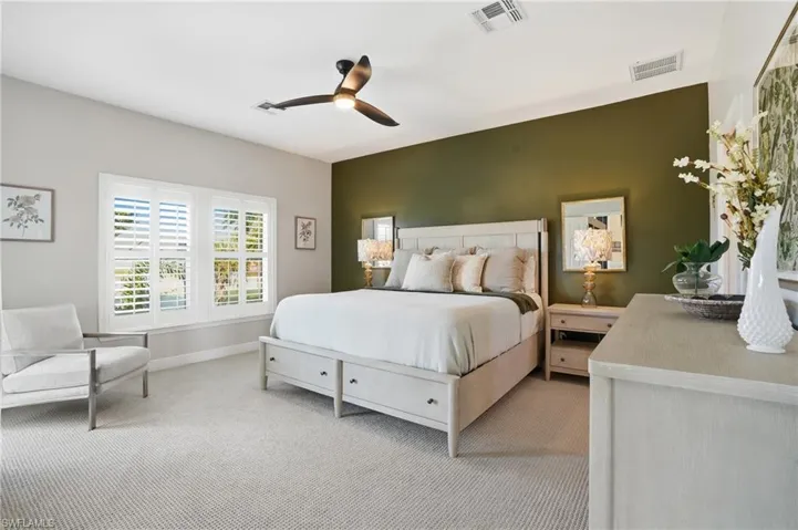 Bedroom with carpet floors and a ceiling fan - Virtually Edited