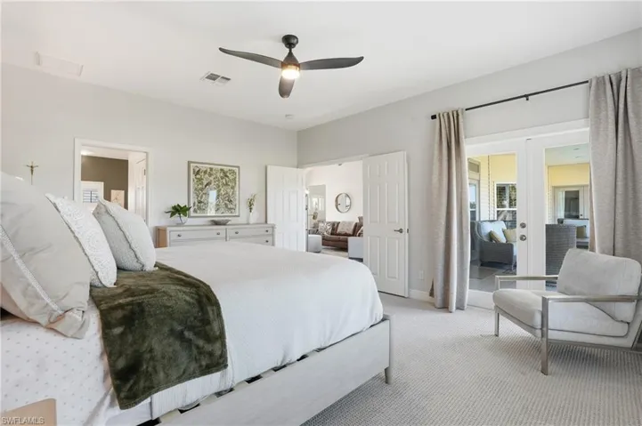 Bedroom featuring french doors, a ceiling fan, carpet floors, and access to outside - Virtually Edited