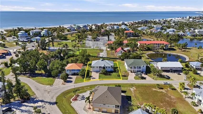 Aerial view of residential area featuring a nearby body of water - Virtually Edited