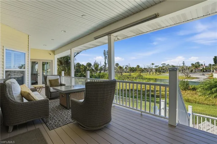 Wooden terrace with a water view and french doors - Virtually Edited